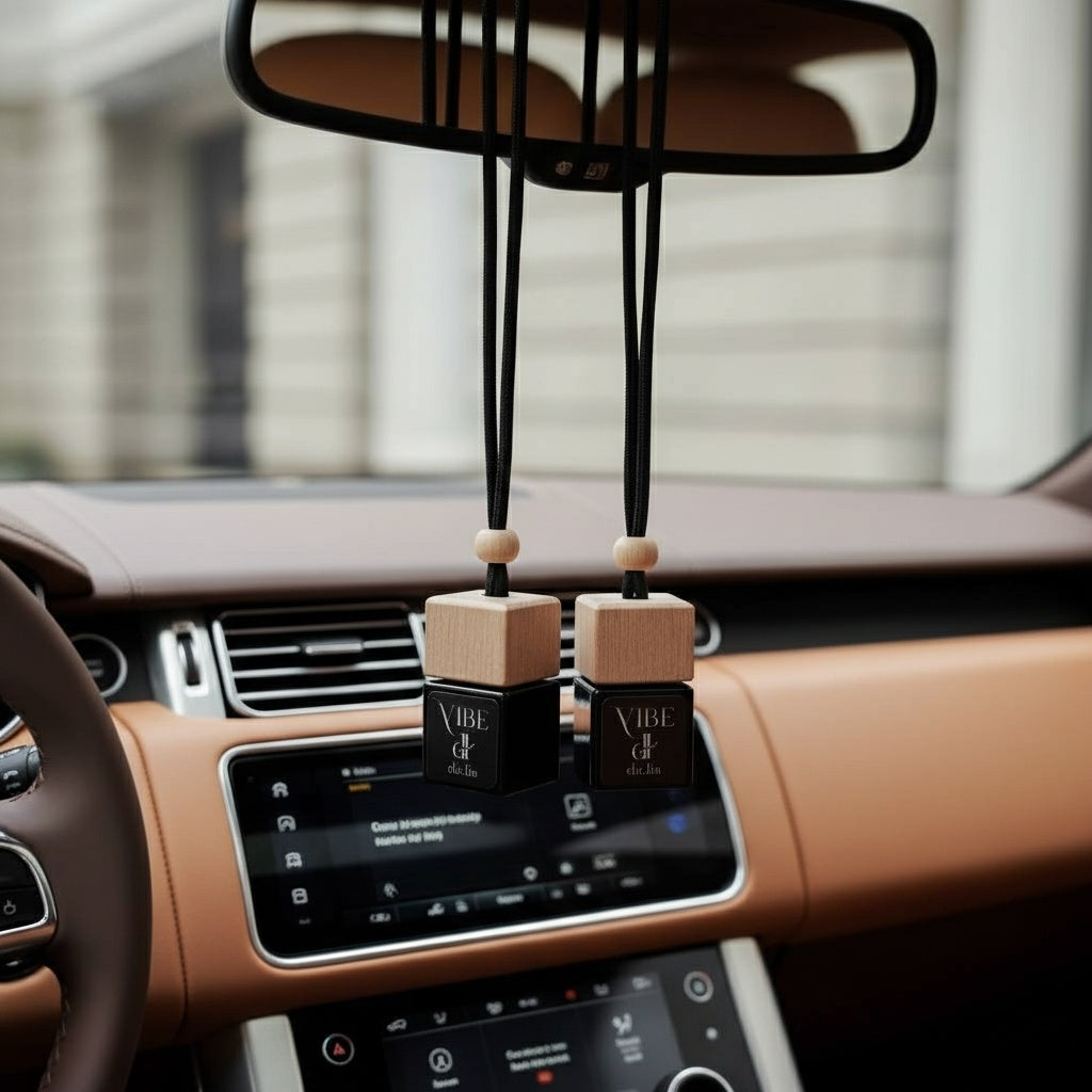 VIBE hanging car freshener surrounded by swirling tobacco, soft woods, and floral notes.