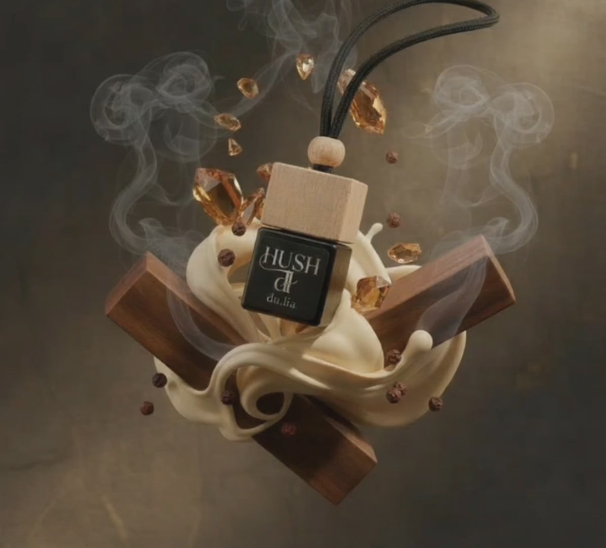 HUSH hanging car freshener surrounded by smoky tobacco and warm vanilla notes.