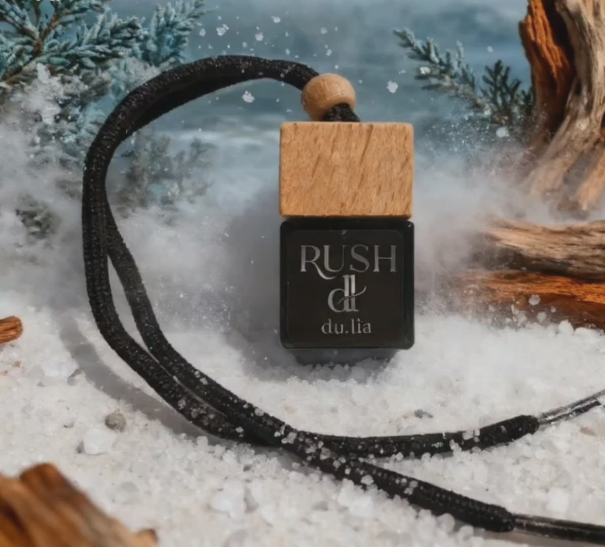 RUSH hanging car freshener photographed by ocean waves and driftwood scenery.