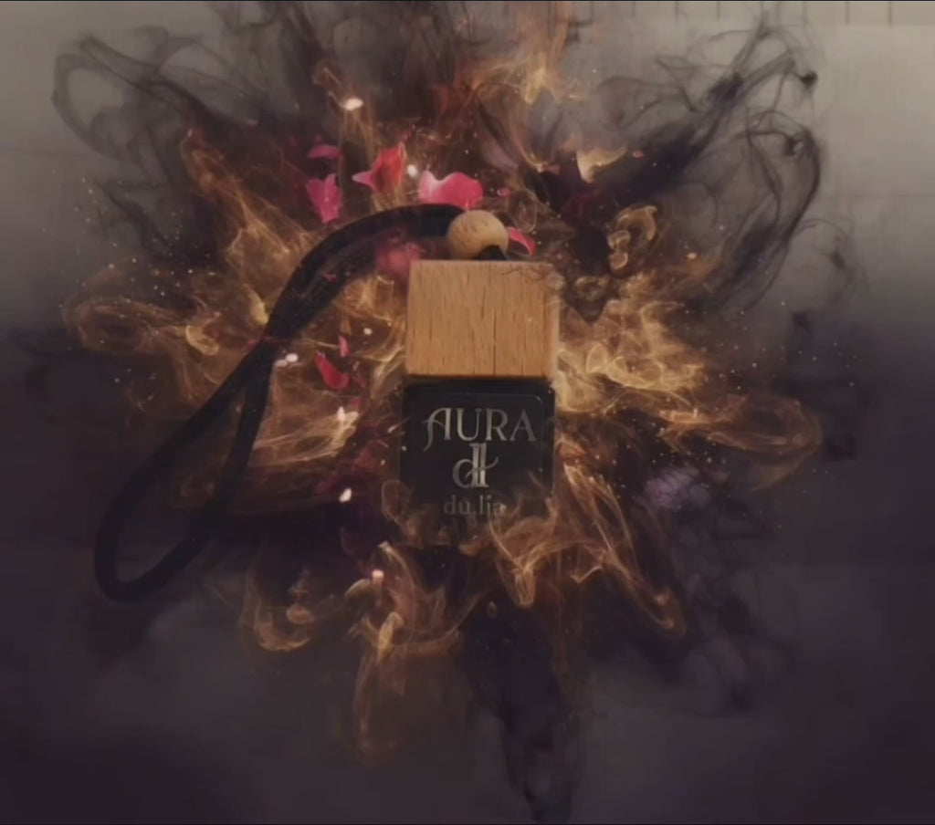 Premium AURA car freshener featuring spiced cardamom and oud with a smooth vanilla-amber finish.